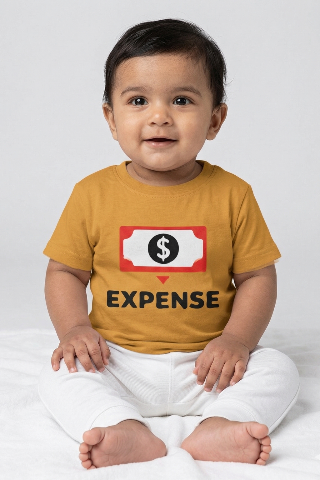 Child wearing a mustard yellow t-shirt with a graphic and text on a white background