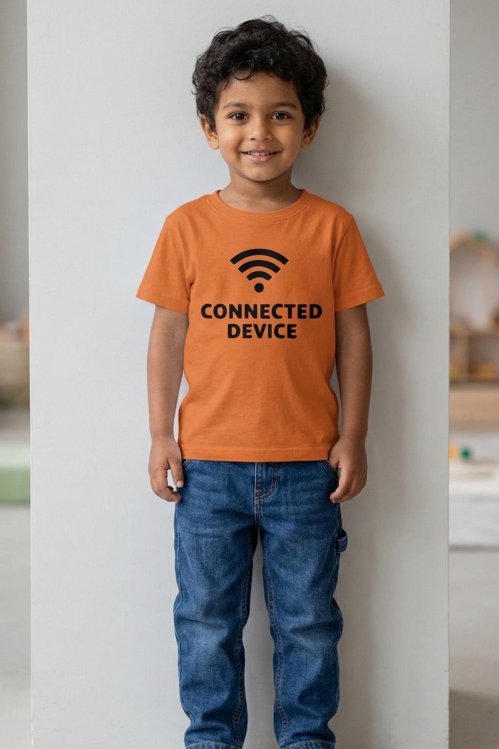 Child wearing an orange t-shirt with 'CONNECTED DEVICE' text and Wi-Fi symbol.