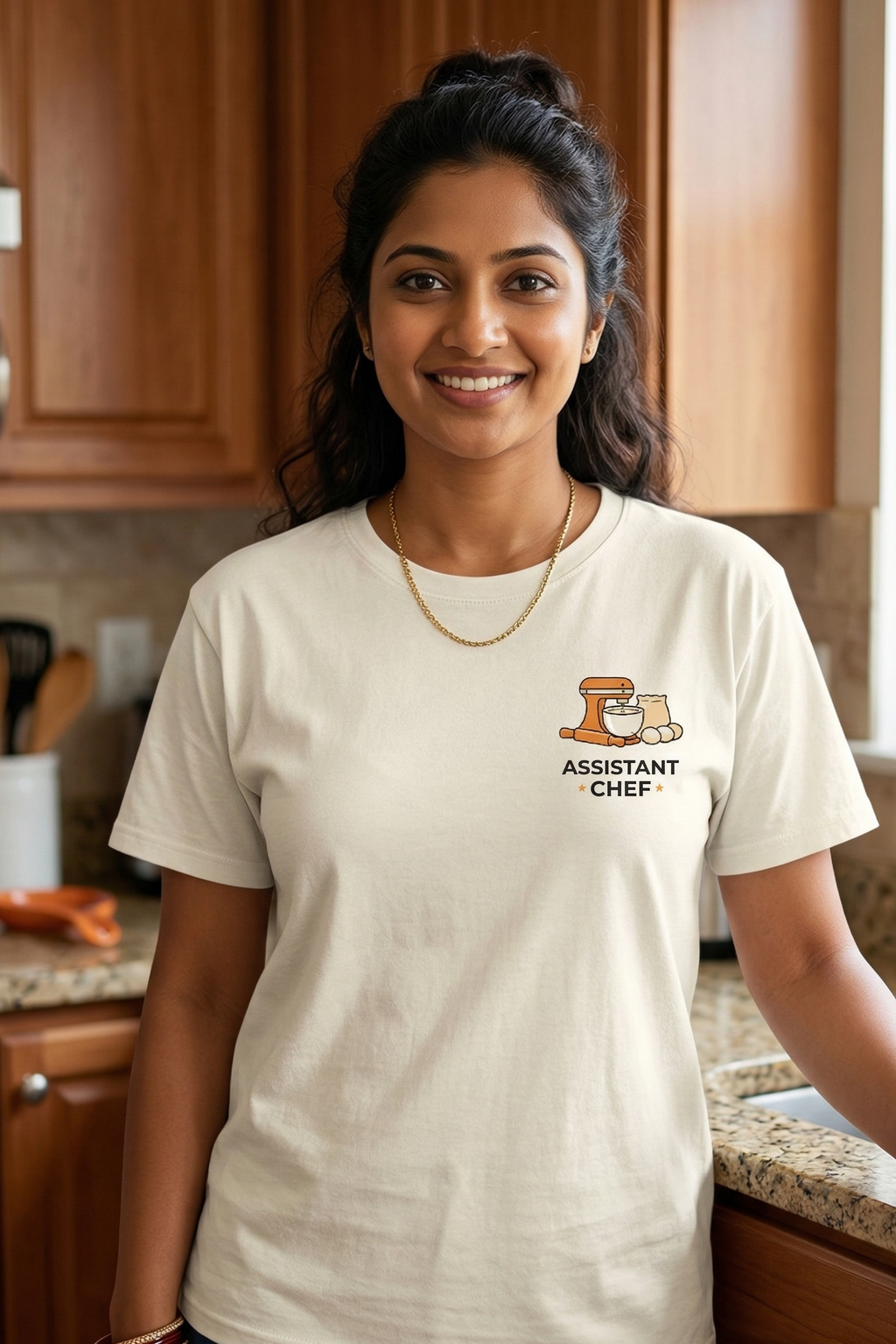 Woman wearing a 'Assistant Chief' t-shirt in a kitchen