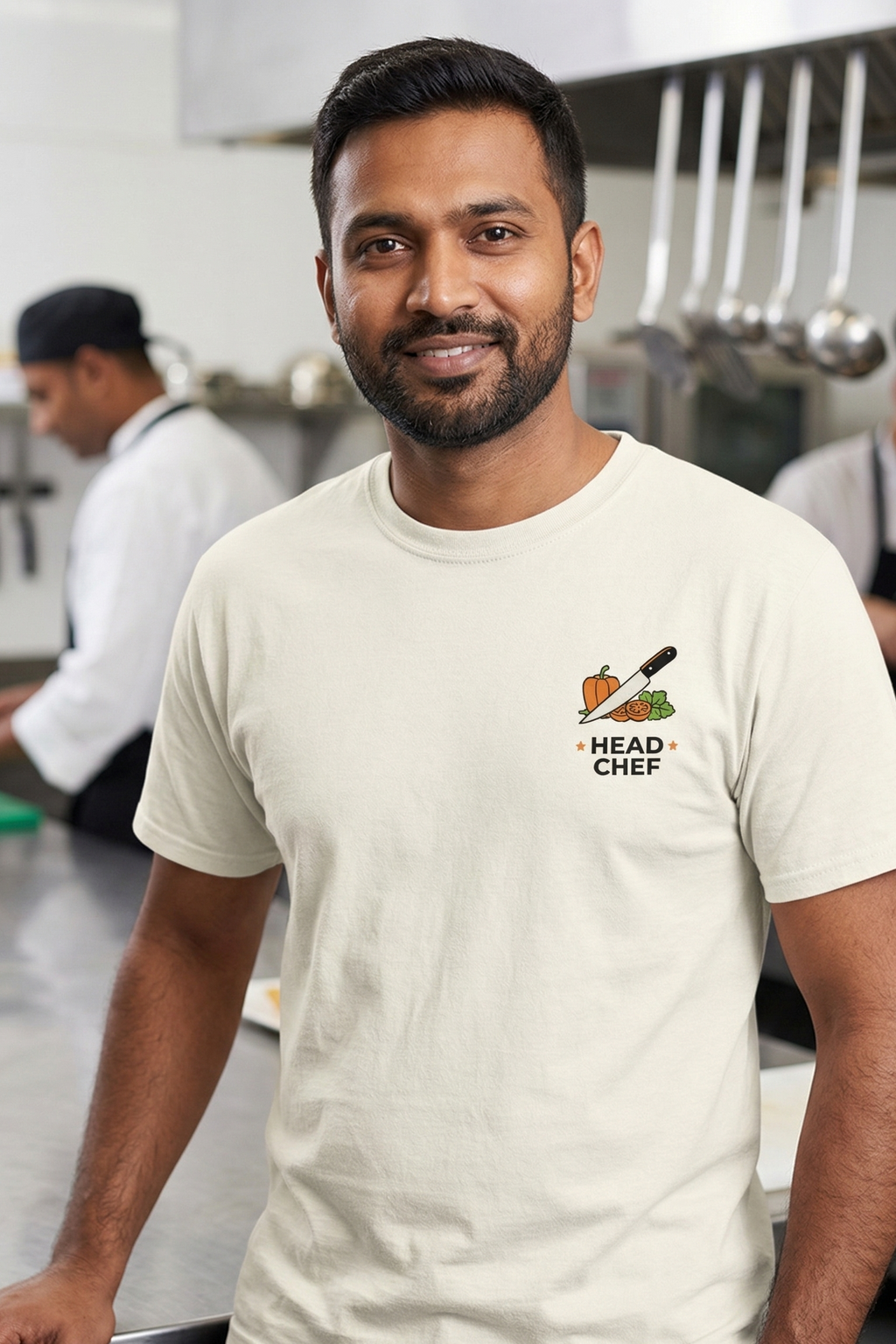 Man wearing a 'Head Chef' t-shirt in a kitchen setting