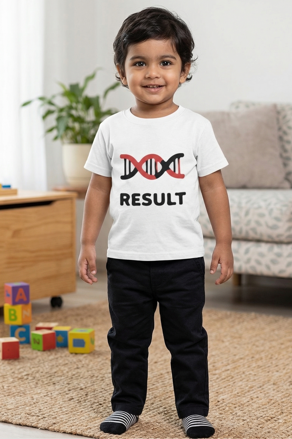 Child wearing a white t-shirt with a DNA double helix design and 'RESULT' text, standing in a living room.