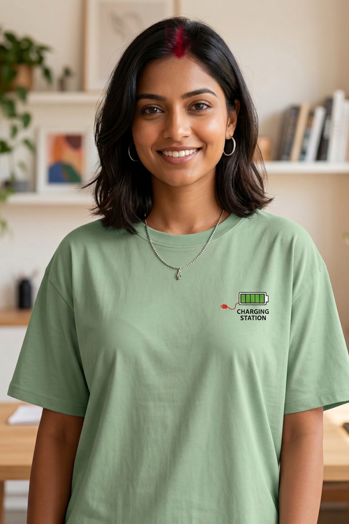 Woman wearing a green t-shirt with a logo in a home setting