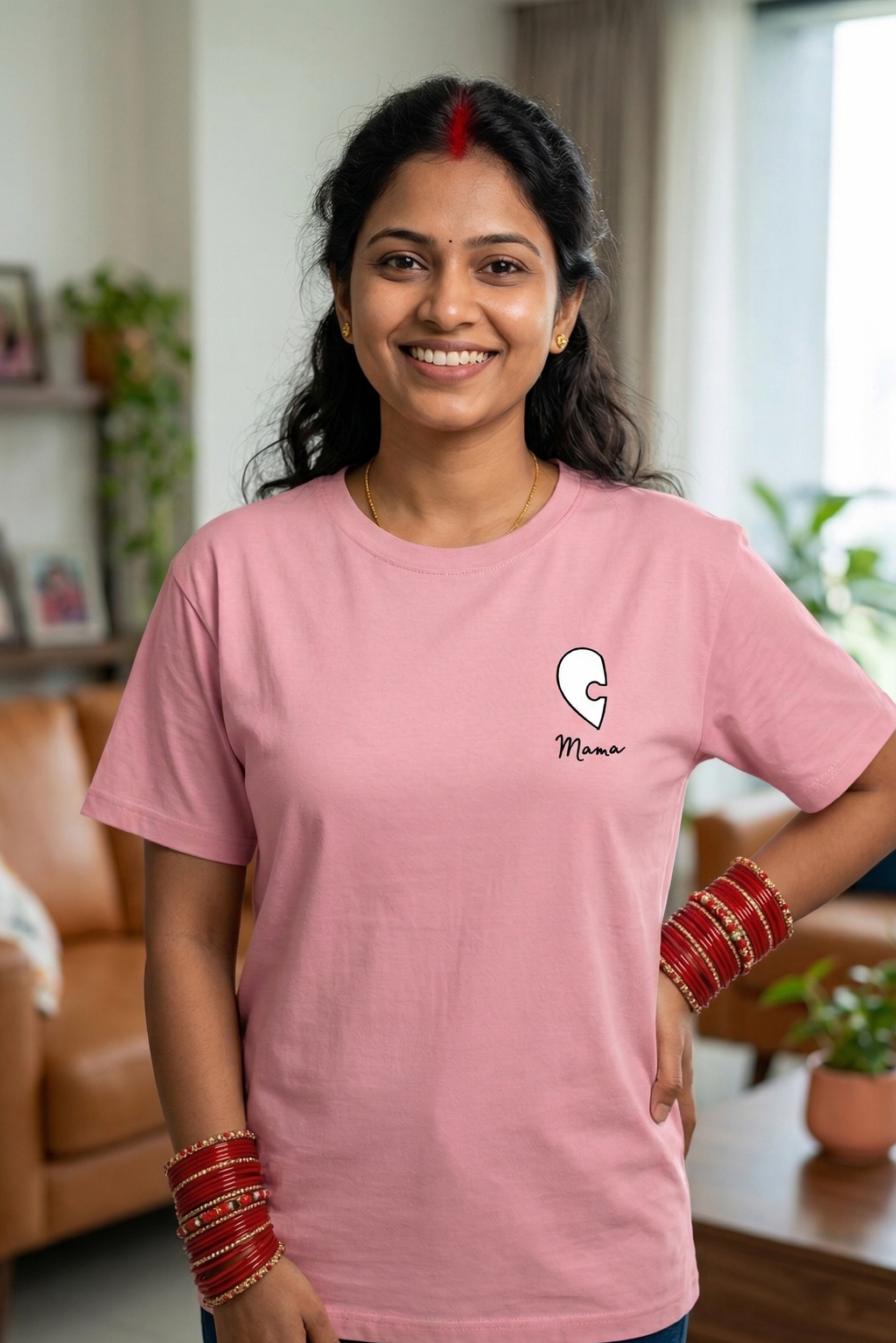 Woman wearing a pink t-shirt with a logo in a living room