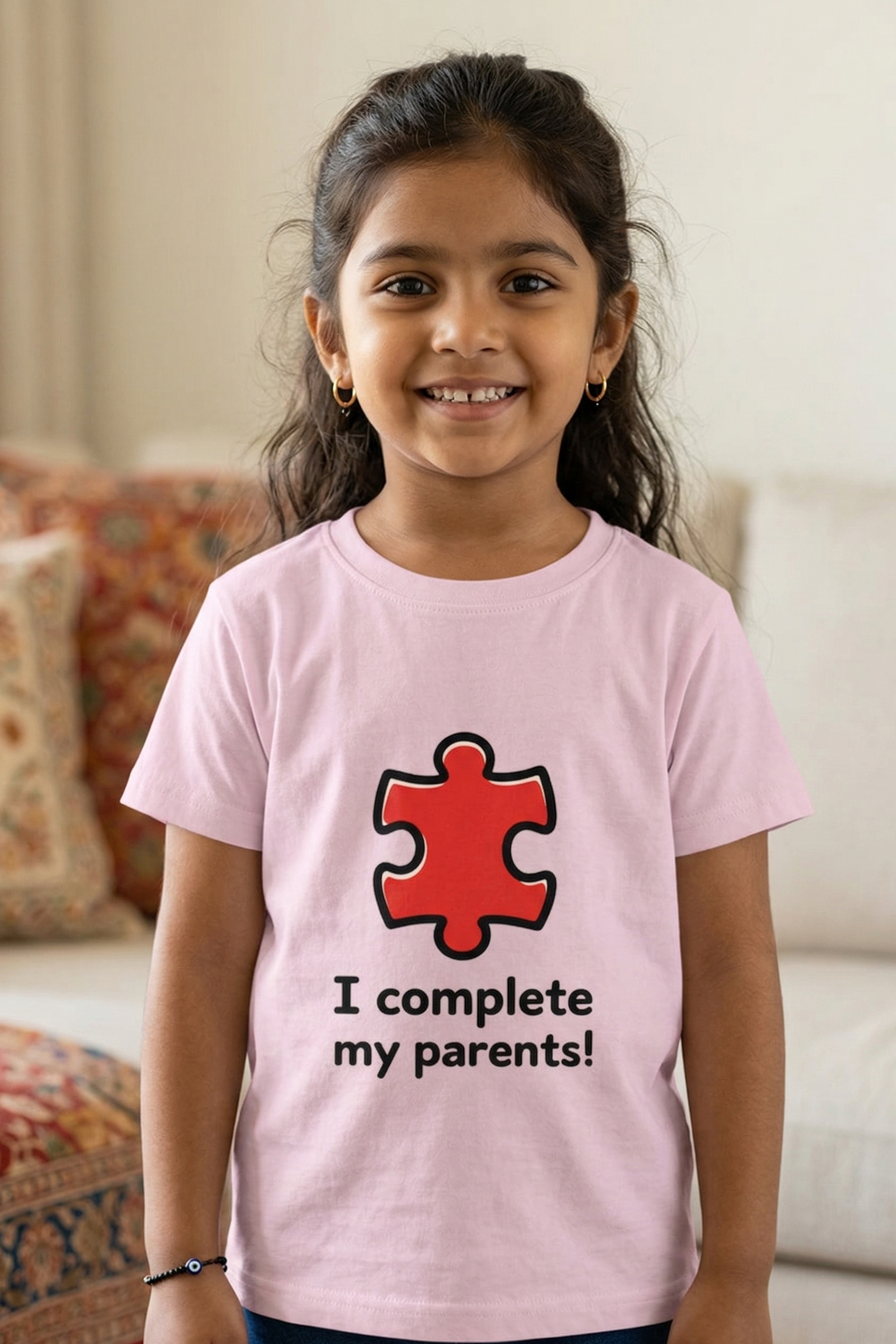 Young girl wearing a pink t-shirt with a red puzzle piece design and text in a living room.