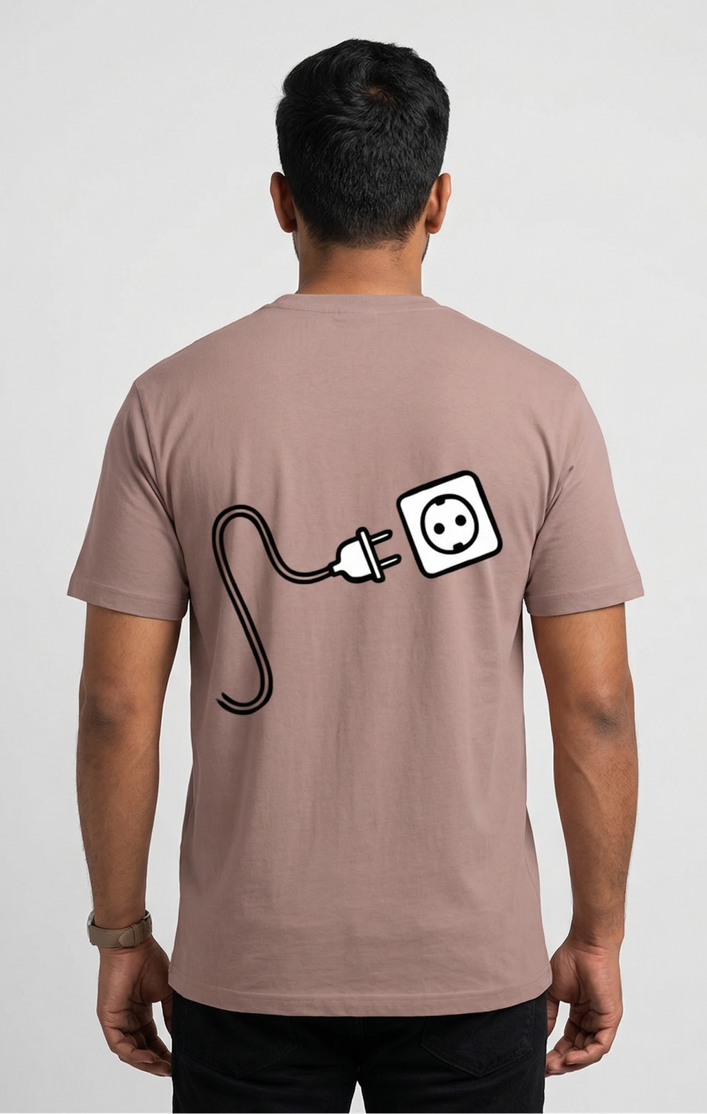 Person wearing a brown t-shirt with a graphic design on the back against a white background