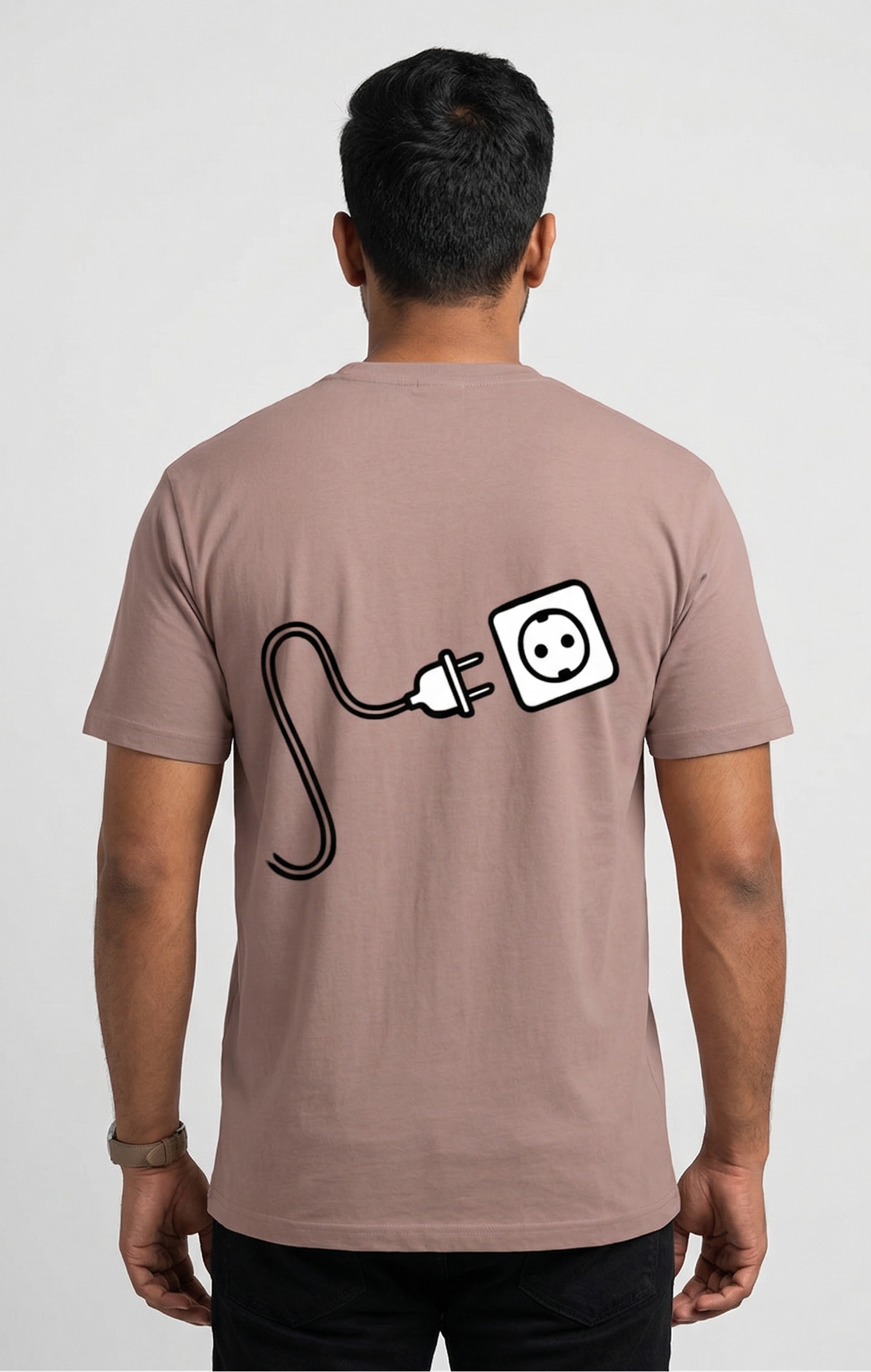 Person wearing a brown t-shirt with a graphic design on the back against a white background